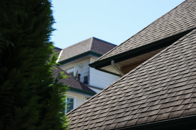 Professional roofer at work on residential property